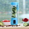 Blue portable blender with ingredients on a wooden surface