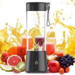 Black portable blender with fruit and juice on a white background